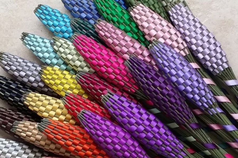 A bunch of lavender wands plaited with ribbons.